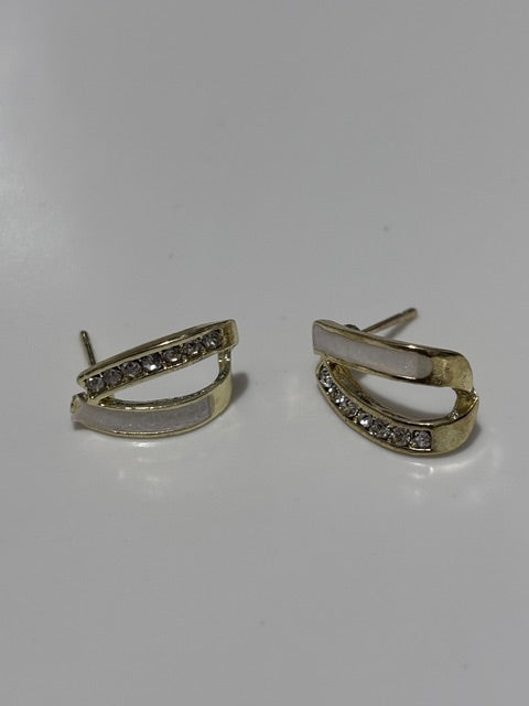 Gold hoop earrings with small stones on a white background