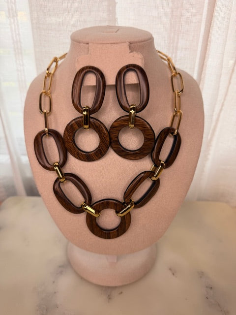 Wooden necklace with gold  accents and matching earrings on a mannequin head