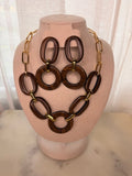 Wooden necklace with gold  accents and matching earrings on a mannequin head