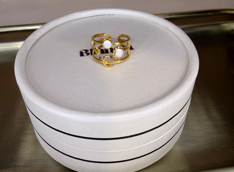 Gold celestial ring on a white  jewelry box