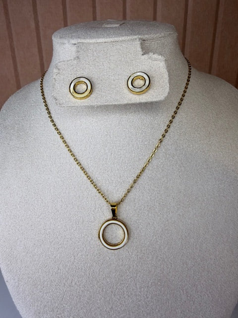 Gold necklace and earring set of circle white pearlescent pendant on a mannequin bust with a plain background