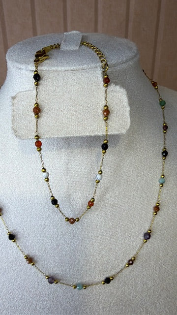 Necklace with multicolored beads on a mannequin bust against a neutral background