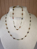 Necklace with multicolored beads and matching bracelet on a mannequin bust