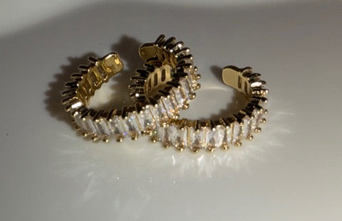 Gold and diamond open rings on a white background