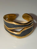 Gold and black ring on a white background