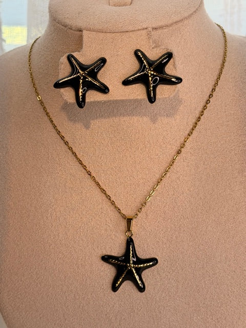 Necklace with black starfish pendants and matching earrings on a mannequin bust