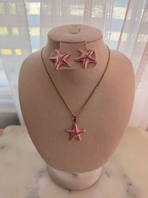 Necklace with pink star pendants on a mannequin bust against a blurred indoor background