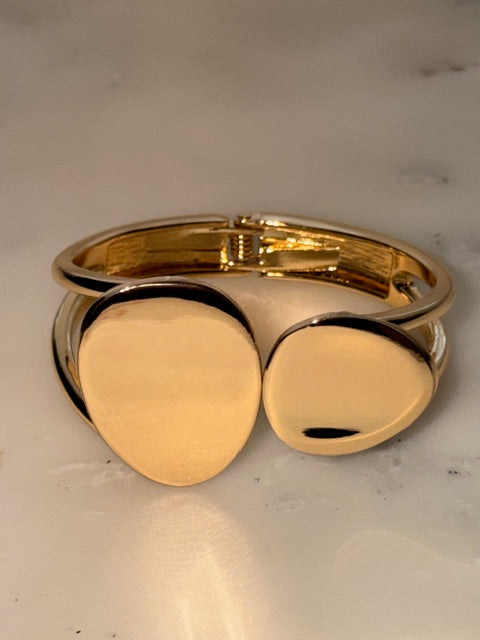 Gold double circular bangle on a light gray background