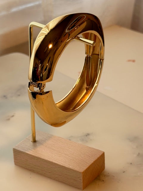 Gold ring on a wooden block against a marble background