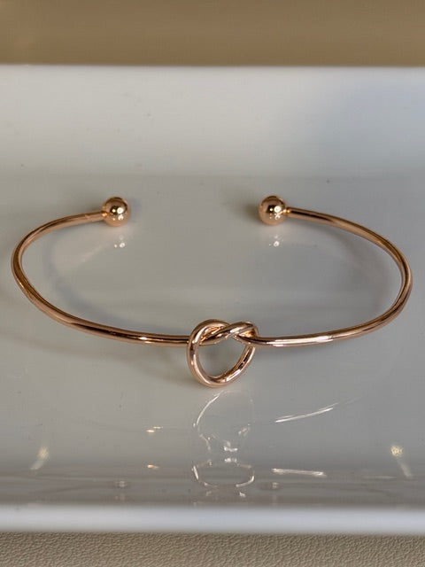 Rose gold bracelet on a white background