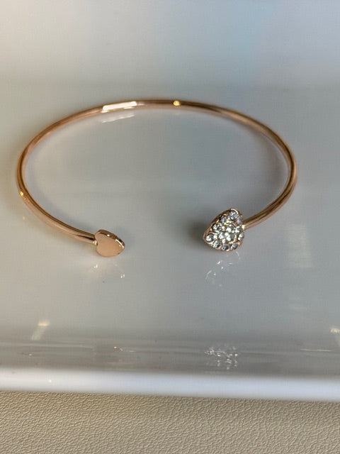 Rose Gold bracelet with a heart-shaped diamond on a light background