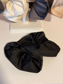 Black satin headband on a white background