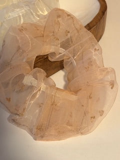 Translucent beige fabric draped over a wooden frame on a light background