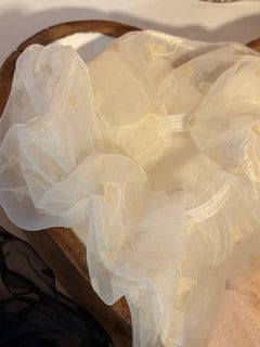 Close-up of a white fabric with heart patterns on a wooden surface