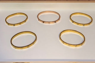 Set of gold bracelets on a white background