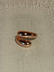 Rose gold hoop earrings on a light gray background