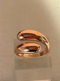 Rose gold ring on a reflective surface