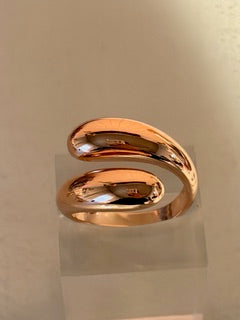 Rose gold ring on a reflective surface