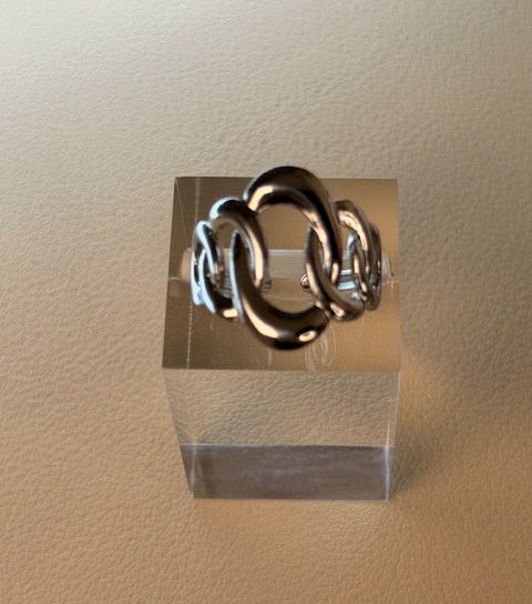  Interlocking circles on a silver ring on a beige background