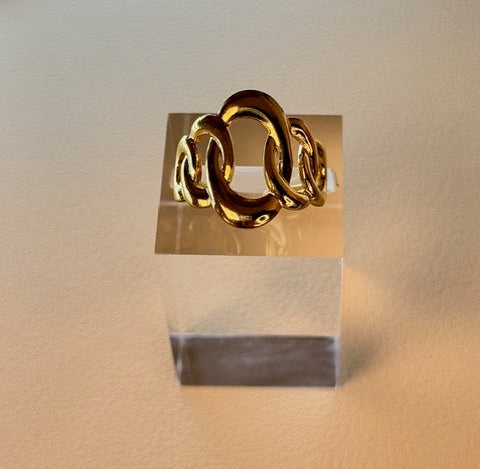 Gold ring on a neutral background.