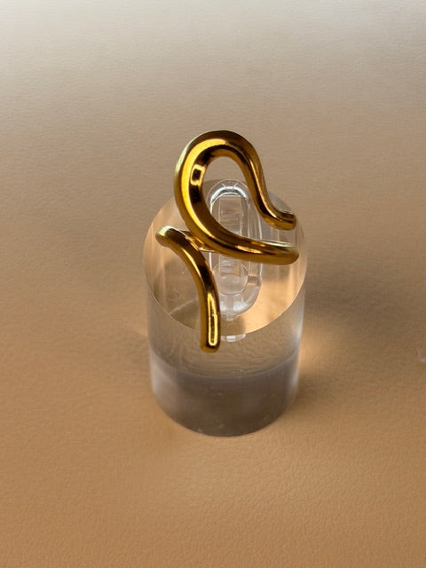Irregular open ring on a beige background