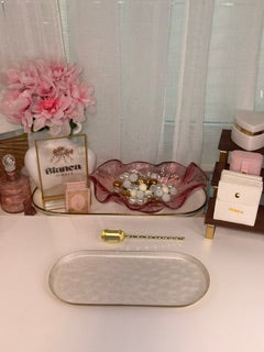Pink bowl with beads, flowers on a white background.